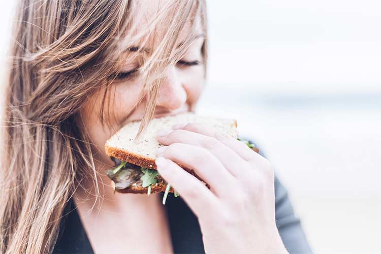 girl eating a sandwich